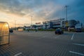 Krakow, Poland: An almost empty open parking area or space against supermarket mall or galeria during sunset