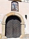 A heavy studded doorway with a painting mounted above in the courtyard of Wawel Castle