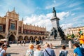 Sukiennice and Adam Mickiewicz Monument at Main Market Square Rynek Glowny in Krakow, Poland Royalty Free Stock Photo