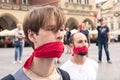 Krakow, Poland, June 01, 2018, Two guys with red ribbon tied mouths protesting against censorship and prohibition of freedom of s