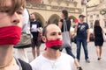 Krakow, Poland, June 01, 2018, Two guys with red ribbon tied mouths protesting against censorship and prohibition of freedom of s