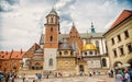 Krakow, Poland - June 04, 2017: Wawel cathedral with chapels on cloudy sky. People tourists on square infront catholic