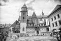 Krakow, Poland - June 04, 2017: Wawel cathedral with chapels on cloudy sky. People tourists on square infront catholic