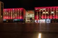 Beautiful and colorful glowing facade of Krakow shopping mall over main railway station at dark