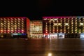 Beautiful and colorful glowing facade of Krakow shopping mall over main railway station at dark