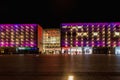 Beautiful and colorful glowing facade of Krakow shopping mall over main railway station at dark