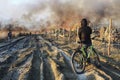 KRAKOW, POLAND - MARCH 28, 2012: The cyclist is watching a big fire on the European estate
