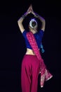 Krakow, Poland - March 22, 2015: A female dressed up Indian traditional cloths performing classical dance on stage
