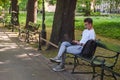 Krakow, Poland - May 19, 2022: man sitting at the bench city park