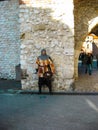 Krakow, Poland - October 09, 2012: The past in the present. Medieval city guard at the gates of the city