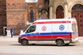 Krakow, Poland, Polish ambulance with sirens on moving, driving through the Cracow Main Market Square, emergency vehicle closeup