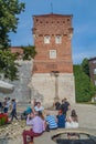 KRAKOW, POLAND - SEPTEMBER 3, 2016: People sit in front of Thieves Tower of Wawel castle in Krakow, Pola Royalty Free Stock Photo