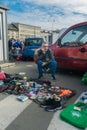 Krakow, Poland - September 21, 2018: Polish vendor waiting for buyers in a parking lot. He is selling used shoes and