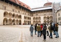 Krakow, Poland - 6th march, 2023: guide with tour group in in Krakow Wawel Royal castle yard. Free tourist walking tours with