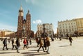 Krakow, Poland - 6th march, 2023: guide with tour group walk together in main square in Krakow. Free tourist walking tours with