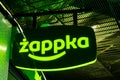 Krakow, Poland, Zappka automated convenience store, shop green signboard logo, detail, closeup, night time. Polish chain store