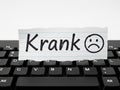 Krank note on keyboard, isolated on white background Royalty Free Stock Photo