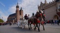 Kraow, Malopolska, Poland - 05/03/2015: Krakow carriage on the Main Market Square in Krakow, in the background St. Mary`s Basilica Royalty Free Stock Photo