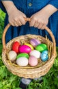 Krashenki homemade eggs in the basket and the hands of a child. Selective focus