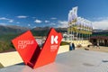 Krasnaya Polyana sign in Krasnaya Polyana mountain ski resort. Scenic blue sky summer landscape