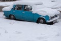 Krasnodar, Russia - December 21 2020: Old Blue Soviet Retro Car Under A Snowdrift Of Snow On The Street.