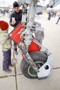 Chassis of a military aircraft. Child at the wheel of the chassis. Su-35 fighter at the air show. Aircraft on the airfield to show