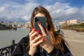 A girl takes a photo or video on an Apple iPhone 11 Pro smartphone with triple-lens camera