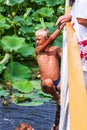 Caucasian boys swim in pond with lotuses gathering coins thrown by people for happiness. Childhood and exploration concept Royalty Free Stock Photo