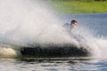 Jet ski watercraft driver in action making water splashes on summer sunny day on river bank