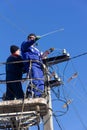 male electricians change the electrical wires at the top of the pole Royalty Free Stock Photo