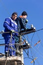 Male electricians perform maintenance work on electrical lines Royalty Free Stock Photo