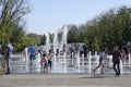 City fountain in the city of Krasnodar. People are walking by the fountain. Water splashes.