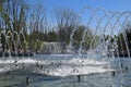 City fountain in the city of Krasnodar. People are walking by the fountain. Water splashes.