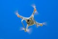 Drone DJI Phantom 4 in flight. Quadrocopter against the blue sky Royalty Free Stock Photo