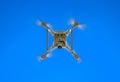 Drone DJI Phantom 4 in flight. Quadrocopter against the blue sky Royalty Free Stock Photo