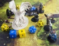 Playing dungeons and dragons game. Map with a figure of dragon and plastic figures of rpg characters Royalty Free Stock Photo