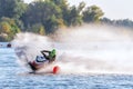 Jet ski racer drives watercraft making turn and splashing while racing at South Russian