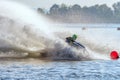 Jet ski racer drives watercraft making turn and splashing while racing at South Russian