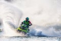 Jet ski racer drives watercraft making turn and splashing while racing at South Russian