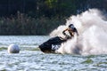 Jet ski racer drives watercraft making turn and splashing while racing at South Russian