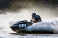 Jet ski racer drives watercraft making turn and splashing while racing at South Russian