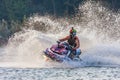 Jet ski racer drives watercraft making turn and splashing while racing at South Russian