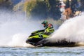 Jet ski racer drives watercraft splashing in sunset while racing at South Russian Aquabike Royalty Free Stock Photo