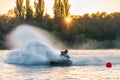 Jet ski racer drives watercraft splashing in sunset while racing at South Russian Aquabike Royalty Free Stock Photo
