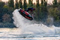 Jet ski sportsman doing freestyle and splashing in evening during South Russian Aquabike