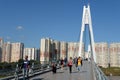 People walk on the Pavshinsky pedestrian bridge over the Moscow river in Krasnogorsk near Moscow