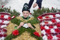 Krasnoilsk, Ukraine - 13 Jan 2017: Dressing a young boy in a straw Bear costume on Malanka