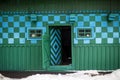 Krasnoilsk, Ukraine - 13 Jan 2017: green and blue traditional wall of a house in a Ukrainian village