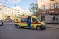 A doctor will climb into a yellow ambulance that stands on Mira Avenue, in the center of Krasnoyarsk, near the cafeteria in the