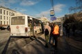 Bus stop Cinema Luch with a white bus and people waiting on Prospekt Mira on a spring day